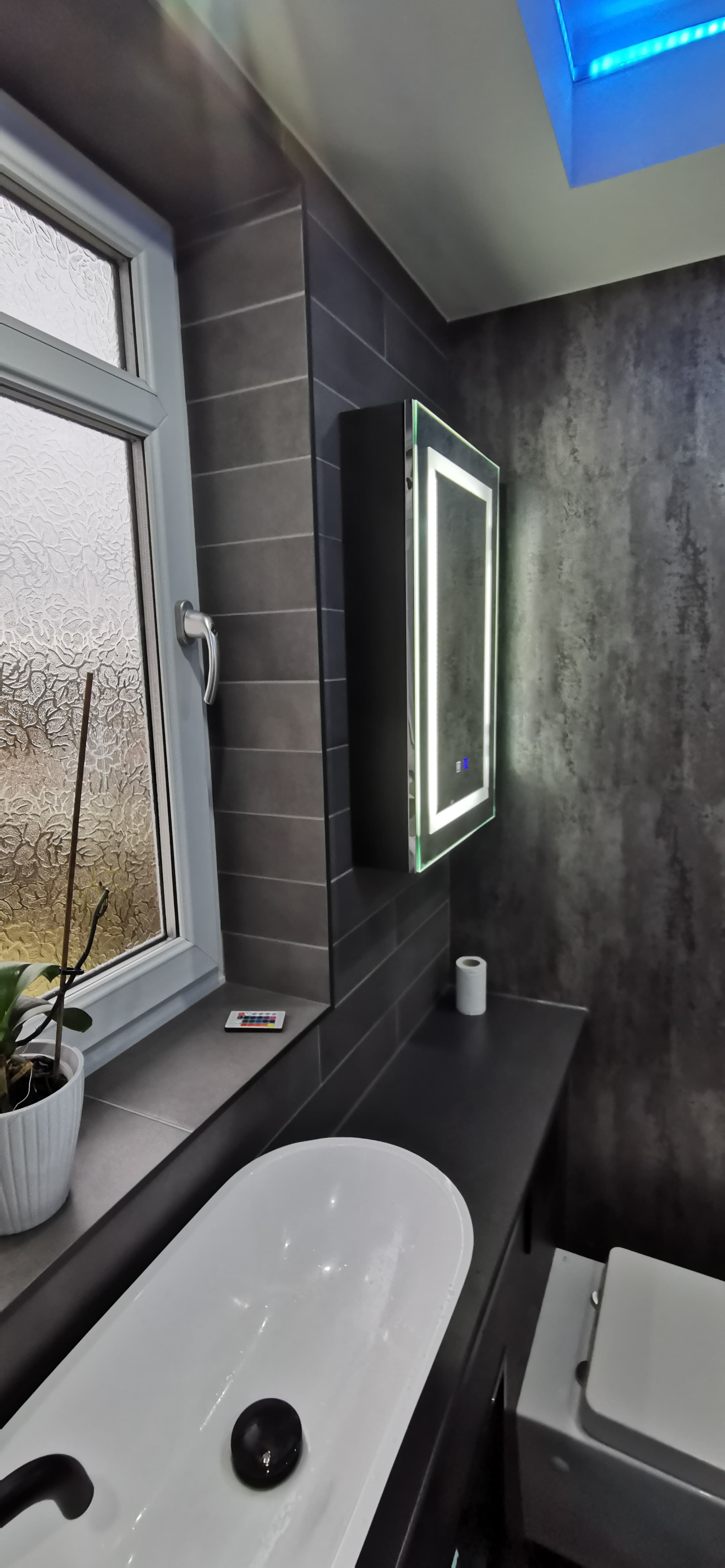 Finished bathroom refit with wall-hung WC, vessel basin and tiled walls