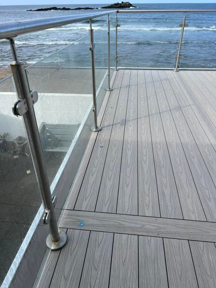 Composite decking build with glass balustrade by Greenwell