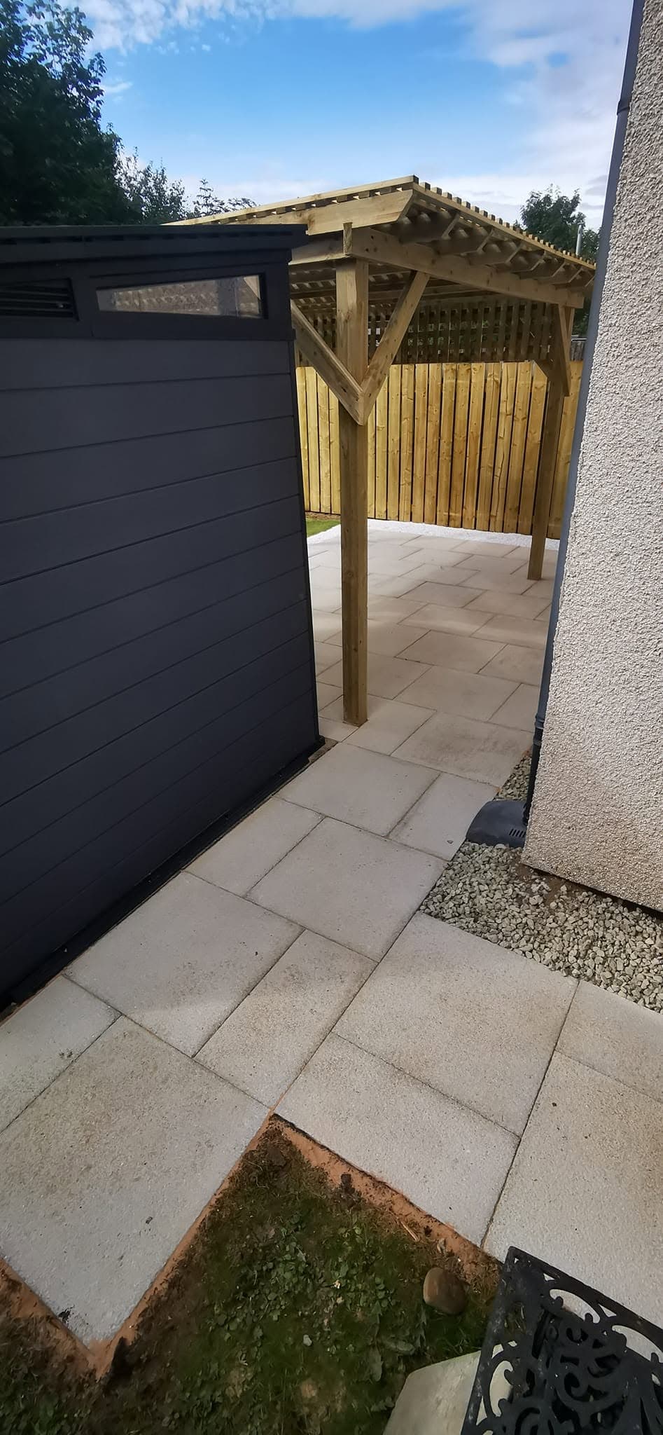 Landscaped garden with slatted timber fencing and clean lawn edges